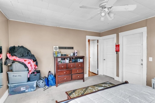 bedroom featuring ceiling fan and light carpet