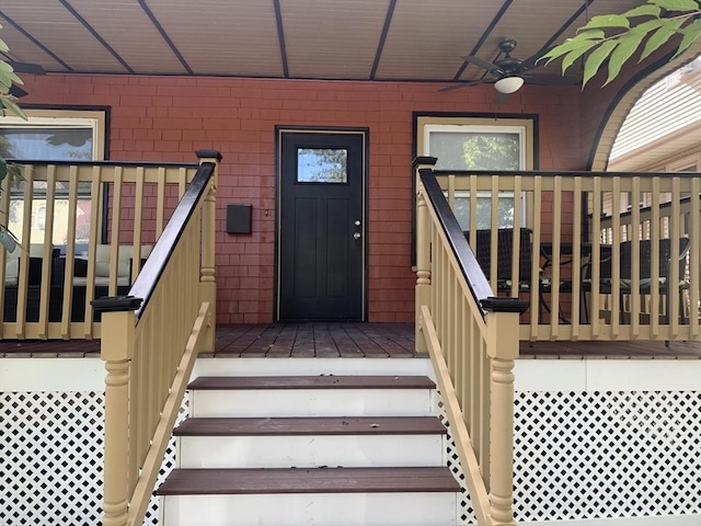 entrance to property featuring ceiling fan