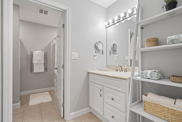 full bathroom featuring baseboards, vanity, visible vents, and tile patterned floors