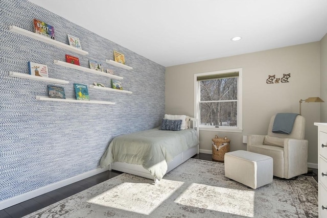 bedroom with recessed lighting, an accent wall, light wood-style floors, baseboards, and wallpapered walls