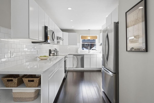 kitchen featuring white cabinets, modern cabinets, pendant lighting, and stainless steel appliances