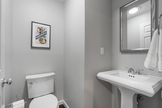 bathroom with toilet and a sink