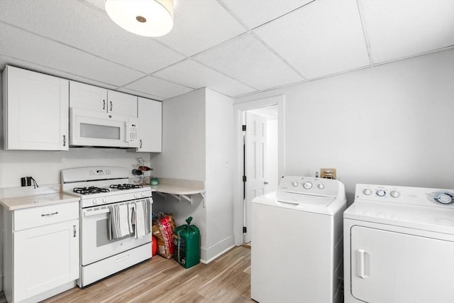 interior space with washer and clothes dryer and light hardwood / wood-style flooring