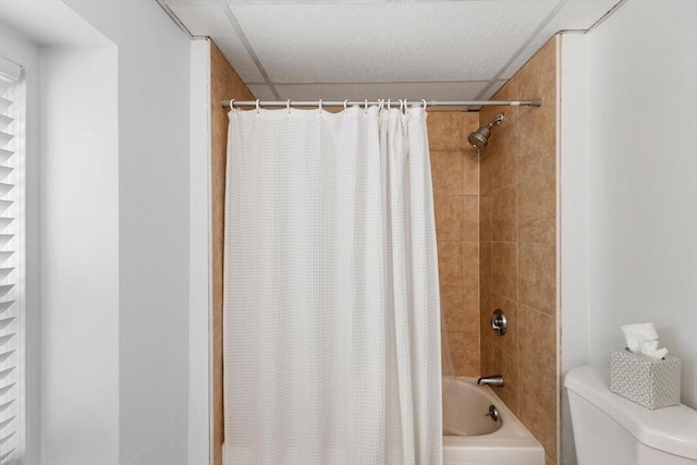 bathroom with toilet and shower / bath combo with shower curtain