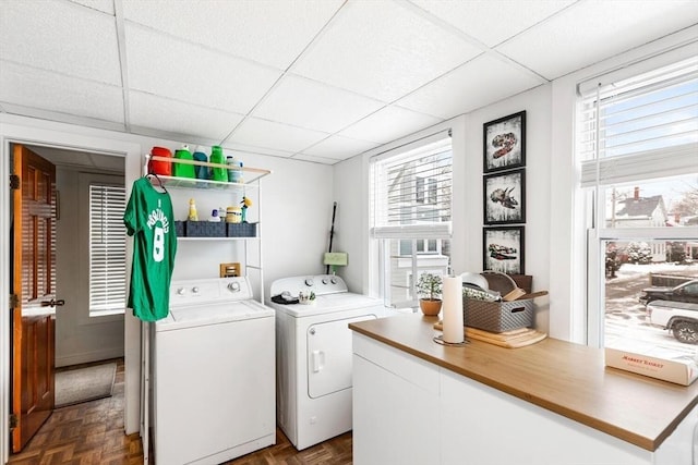 washroom featuring dark parquet floors and washing machine and clothes dryer