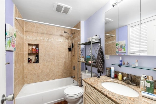 full bathroom featuring vanity, toilet, and tiled shower / bath combo