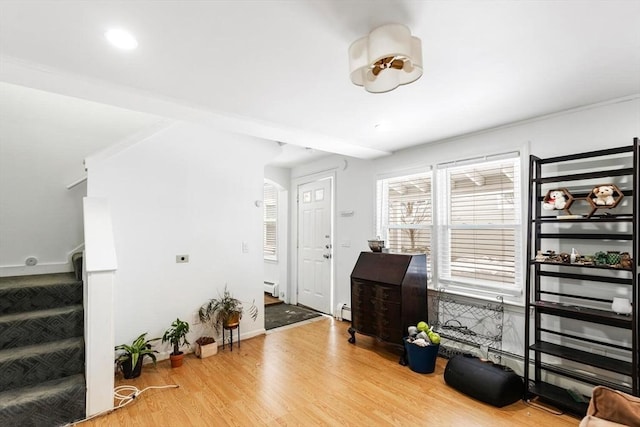 entryway featuring baseboard heating and wood-type flooring