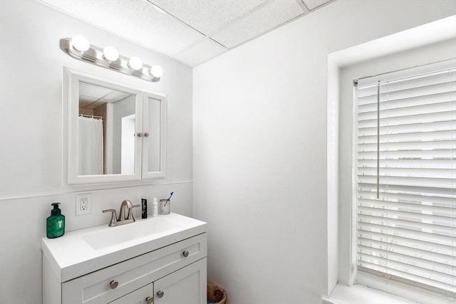 bathroom featuring a drop ceiling and vanity