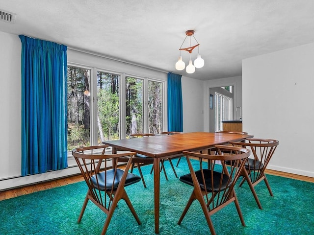 104 Tower Rd, Lincoln, MA 01773 - dining area with visible vents, wood finished floors, and a notable chandelier