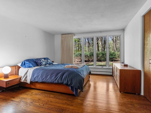 104 Tower Rd, Lincoln, MA 01773 - bedroom featuring wood finished floors and baseboard heating