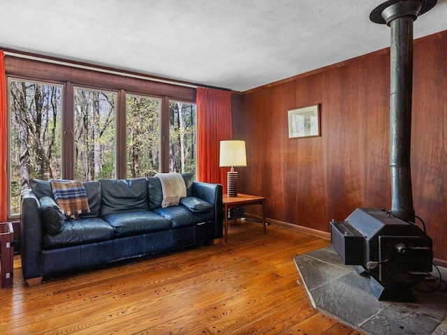 104 Tower Rd, Lincoln, MA 01773 - living area featuring wood-type flooring, a wood stove, and wood walls
