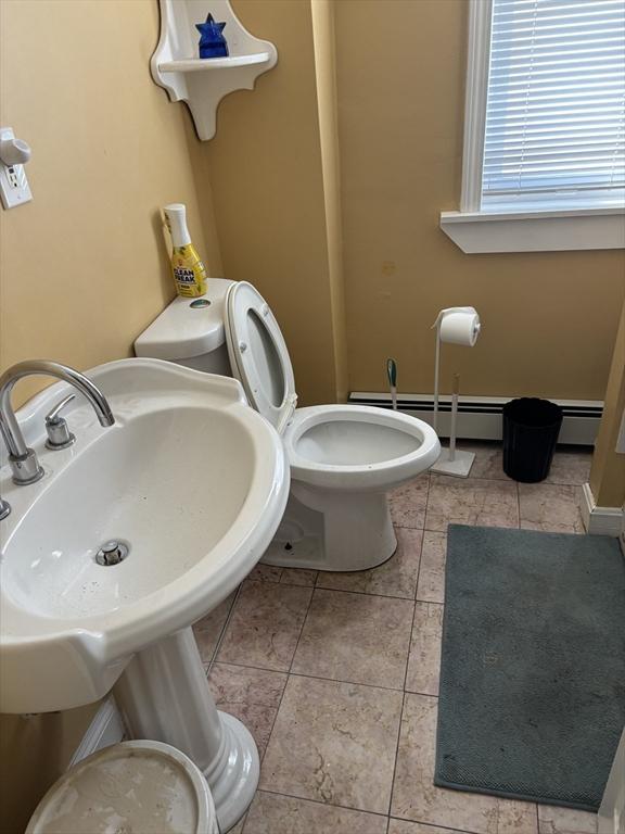 102-104 Robey St, Boston, MA 02119 - half bath featuring tile patterned floors, a sink, a baseboard heating unit, and toilet