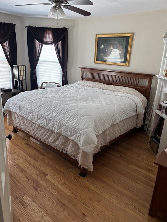 102-104 Robey St, Boston, MA 02119 - bedroom featuring a ceiling fan, wood finished floors, and multiple windows
