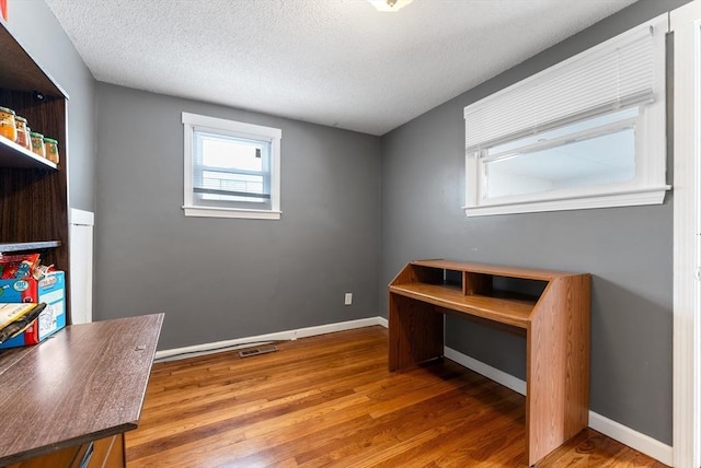 office area featuring hardwood / wood-style floors and a textured ceiling