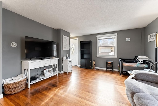 living room with light hardwood / wood-style floors and a textured ceiling