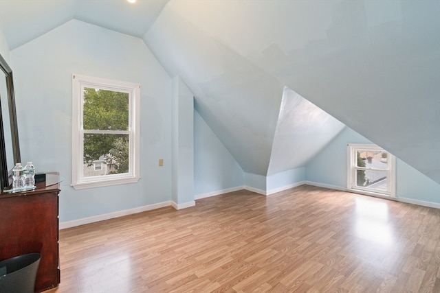 bonus room with light hardwood / wood-style flooring and lofted ceiling