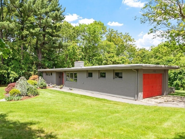 166 Quinapoxet Ln, Worcester, MA 01606 - back of house featuring a lawn, a chimney, driveway, and a garage