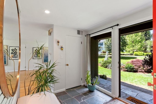 166 Quinapoxet Ln, Worcester, MA 01606 - entrance foyer featuring baseboards, recessed lighting, and dark stone finish floors