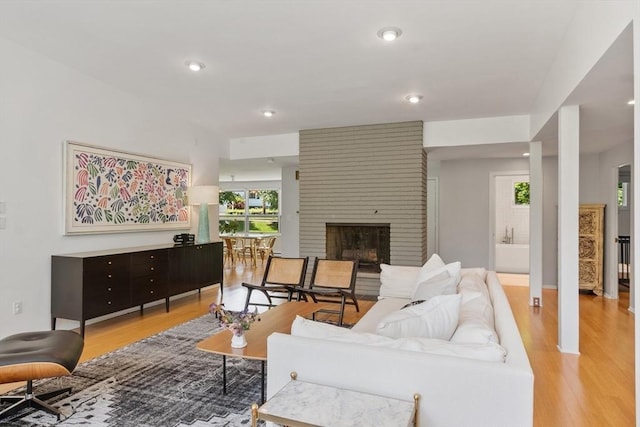 166 Quinapoxet Ln, Worcester, MA 01606 - living area with light wood-style floors, a brick fireplace, and recessed lighting