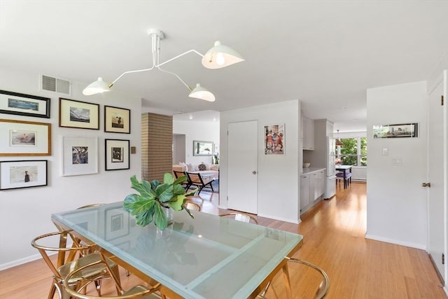 166 Quinapoxet Ln, Worcester, MA 01606 - dining room with light wood-style flooring and baseboards
