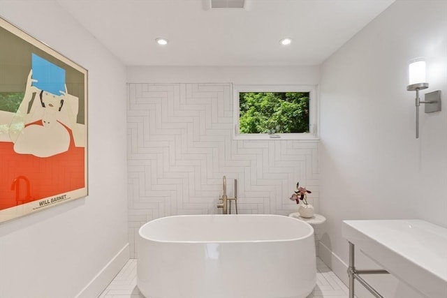 166 Quinapoxet Ln, Worcester, MA 01606 - bathroom featuring a freestanding tub, baseboards, recessed lighting, and tile patterned floors
