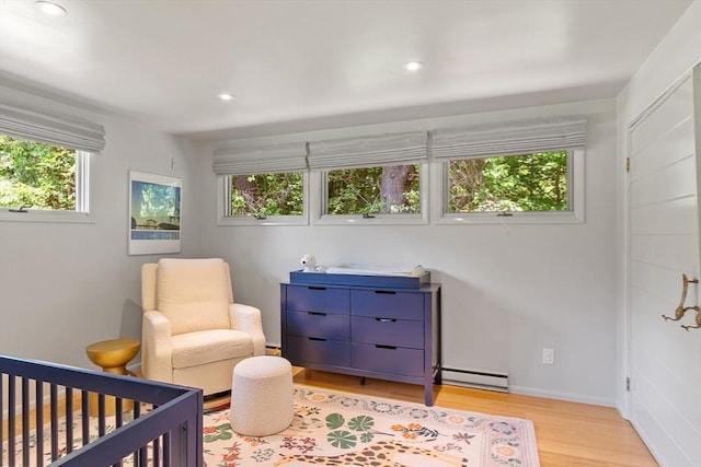 166 Quinapoxet Ln, Worcester, MA 01606 - bedroom with a baseboard radiator, light wood finished floors, recessed lighting, and a nursery area