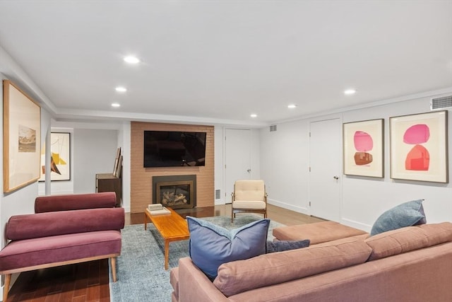 166 Quinapoxet Ln, Worcester, MA 01606 - living room featuring recessed lighting, light wood finished floors, a brick fireplace, and baseboards