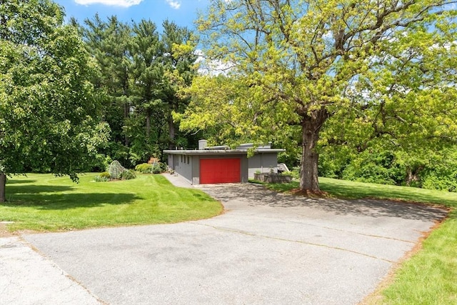 166 Quinapoxet Ln, Worcester, MA 01606 - mid-century modern home with a front yard, a garage, driveway, and stucco siding