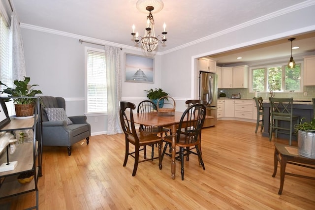24 Sheppard Rd, Bourne, MA 02562 - dining space with light wood finished floors, a chandelier, and ornamental molding