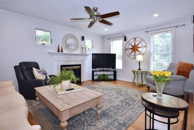 24 Sheppard Rd, Bourne, MA 02562 - living area featuring crown molding, plenty of natural light, a fireplace, light wood-type flooring, and recessed lighting