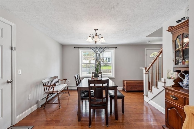 dining room featuring a textured ceiling, stairway, wood finished floors, and a notable chandelier