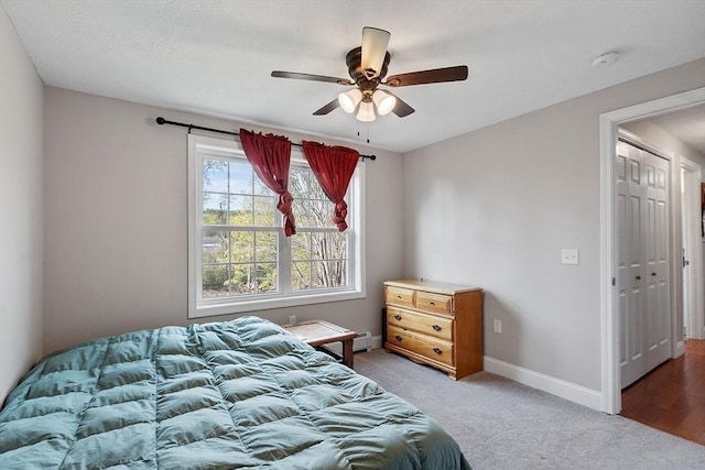 carpeted bedroom featuring baseboards and ceiling fan
