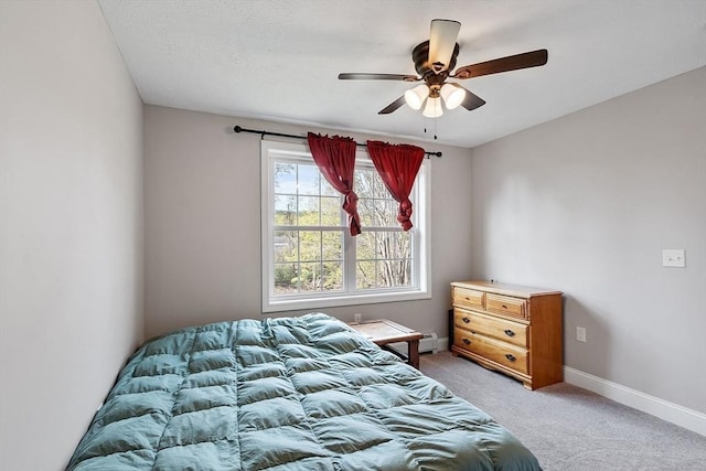 bedroom featuring baseboards, light carpet, and a ceiling fan