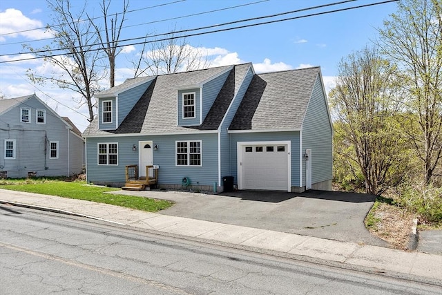 view of front of property featuring a shingled roof, a garage, and aphalt driveway