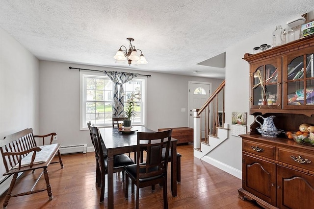dining area with a notable chandelier, a baseboard radiator, a textured ceiling, stairs, and dark wood-style floors