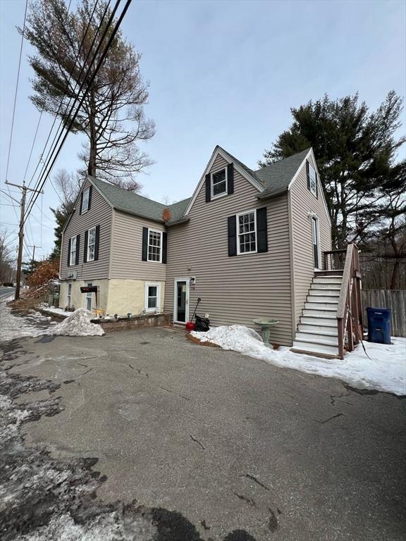 view of front of property featuring stairway