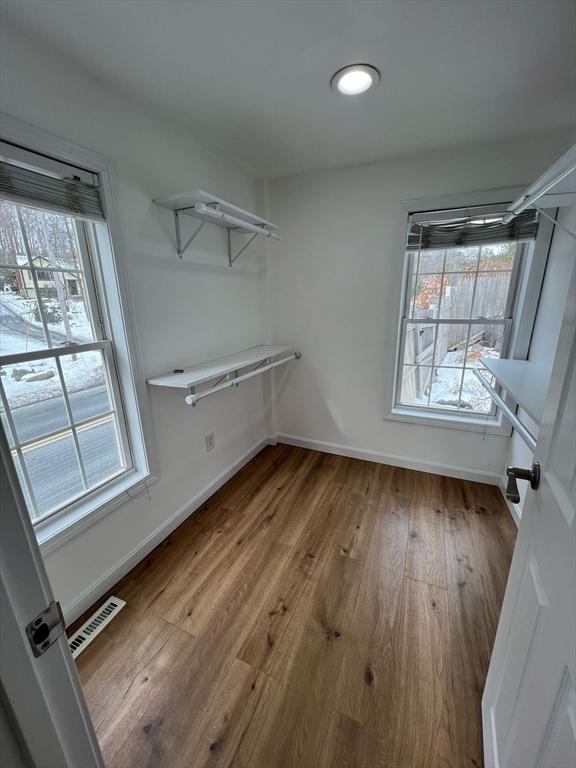 walk in closet featuring visible vents and wood finished floors