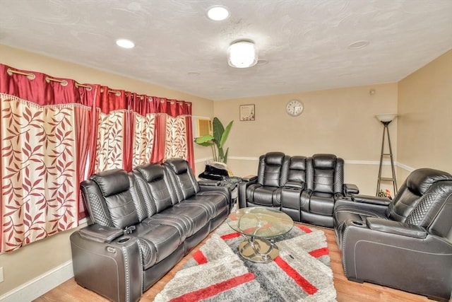 living room with recessed lighting, light wood-type flooring, and baseboards