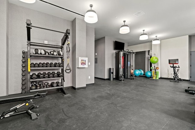 workout area featuring baseboards