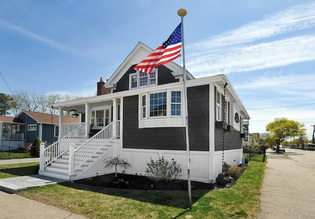 14 Lewis St, Hull, MA 02045 - view of front of home with a chimney, covered porch, and stairs