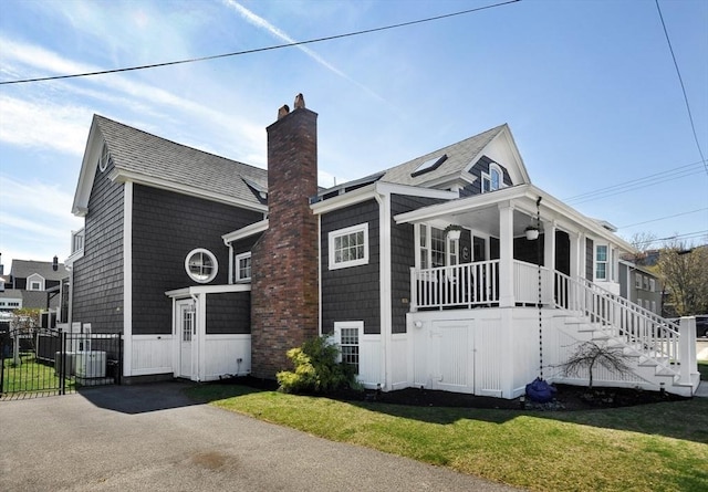 14 Lewis St, Hull, MA 02045 - view of front of house with a chimney, a porch, a gate, stairs, and a shingled roof