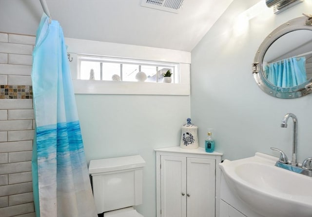 14 Lewis St, Hull, MA 02045 - bathroom with a sink, plenty of natural light, curtained shower, lofted ceiling, and toilet