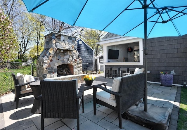14 Lewis St, Hull, MA 02045 - view of patio with an outdoor stone fireplace and fence