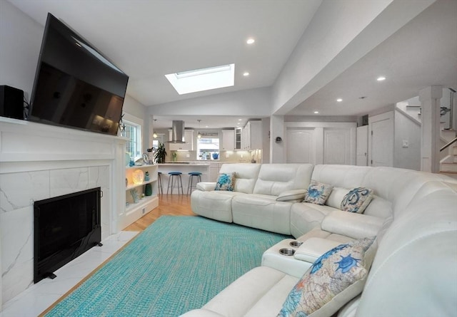 14 Lewis St, Hull, MA 02045 - living room featuring a high end fireplace, a skylight, lofted ceiling, recessed lighting, and stairway