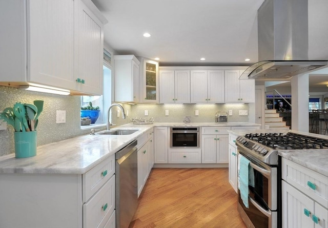 14 Lewis St, Hull, MA 02045 - kitchen featuring stainless steel appliances, island exhaust hood, a sink, tasteful backsplash, and white cabinets