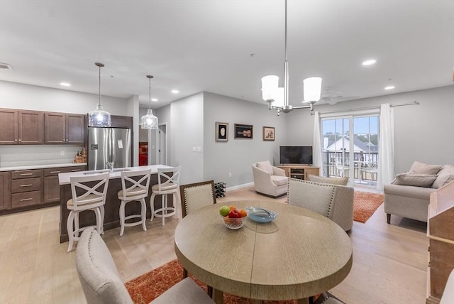 dining room featuring light hardwood / wood-style floors and an inviting chandelier