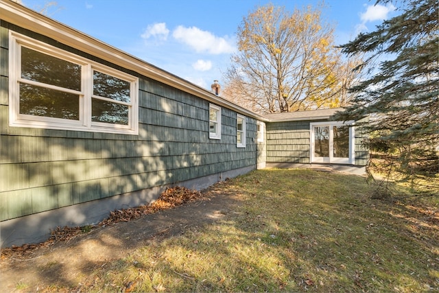 view of side of property with a yard