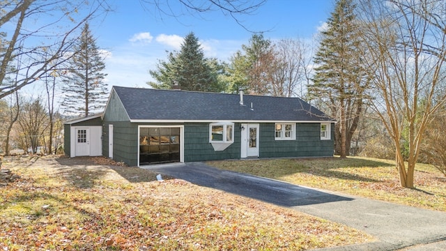 ranch-style house with a front yard and a garage