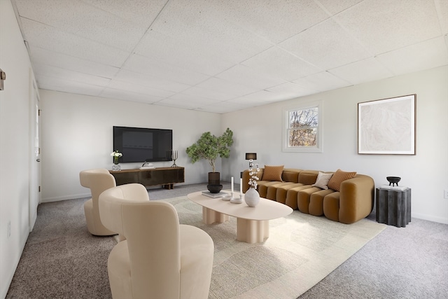 living room featuring carpet flooring and a paneled ceiling