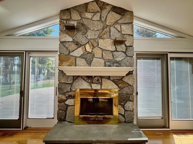 details with visible vents, wood finished floors, and a fireplace
